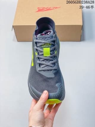 Front view of a gray trail running shoe with neon yellow-green accents
