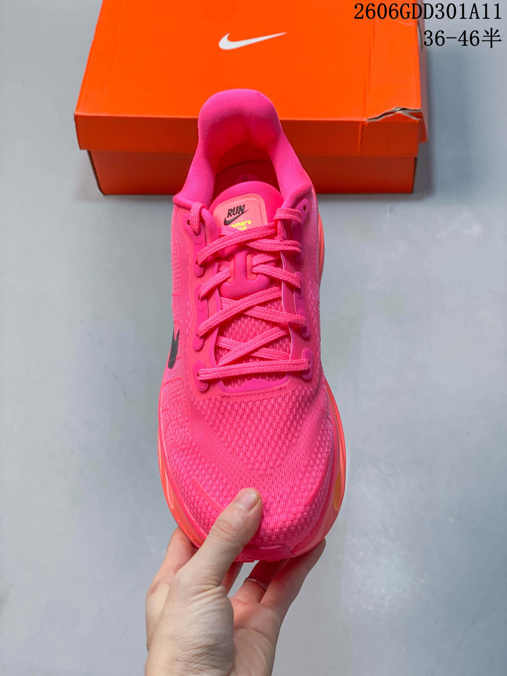 Top view of the hot-pink Nike Vomero Premium shoe showing its laces and textured upper.