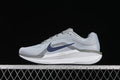 Side view of a light gray Nike Zoom Winflo 11 shoe with navy Swoosh and white midsole