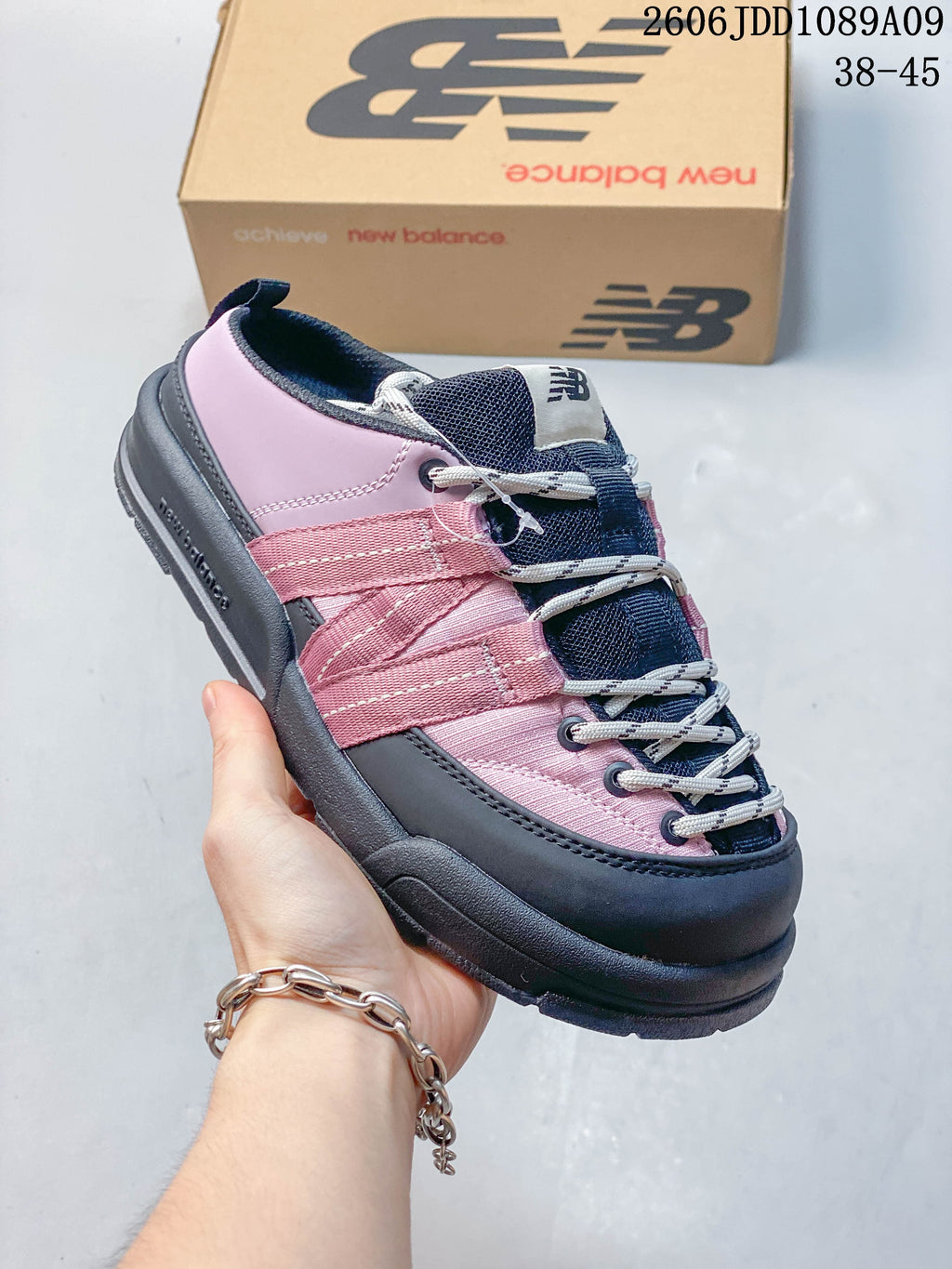 Close-up of a pink and navy New Balance Terrace Mule with webbing straps and laces.