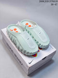 Pair of pale mint Nike Mind 001 closed-toe slides on a Nike Mind box