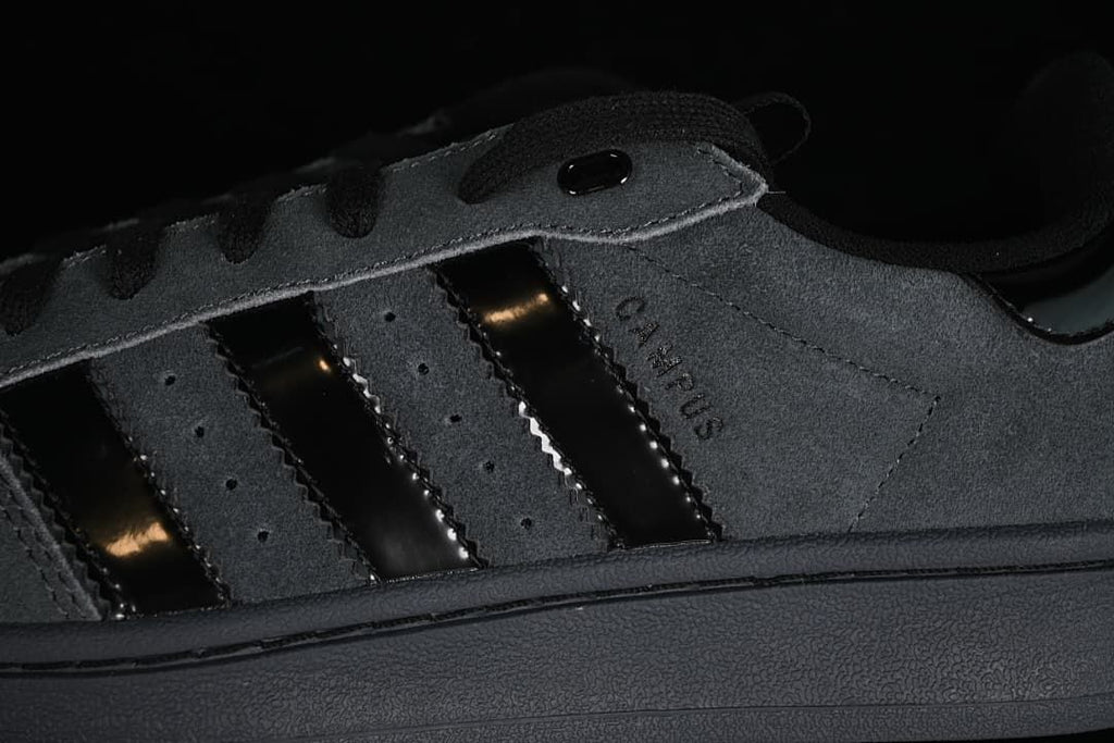 Close-up of charcoal gray side panels, black stripes and Campus lettering