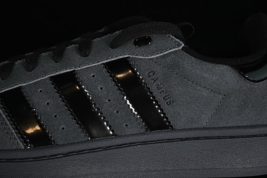 Close-up of charcoal gray side panels, black stripes and Campus lettering