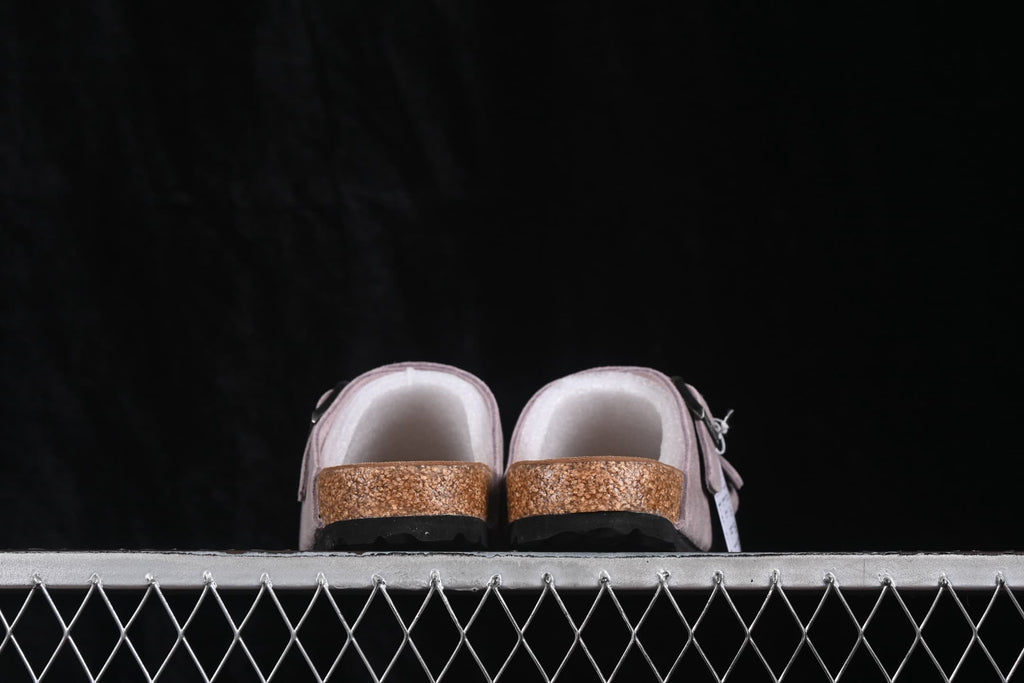 Rear view of lavender two-strap sandals showing the contoured footbed edge and black outsole.