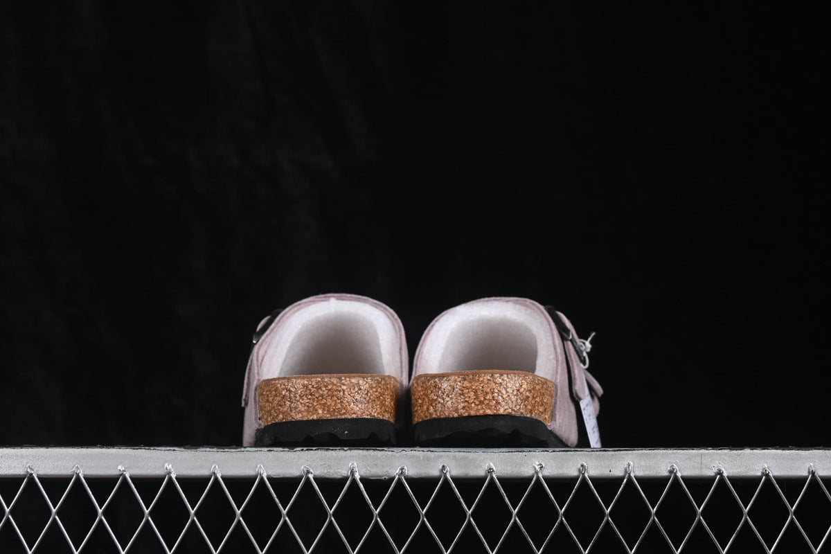 Rear view of lavender two-strap sandals showing the contoured footbed edge and black outsole.