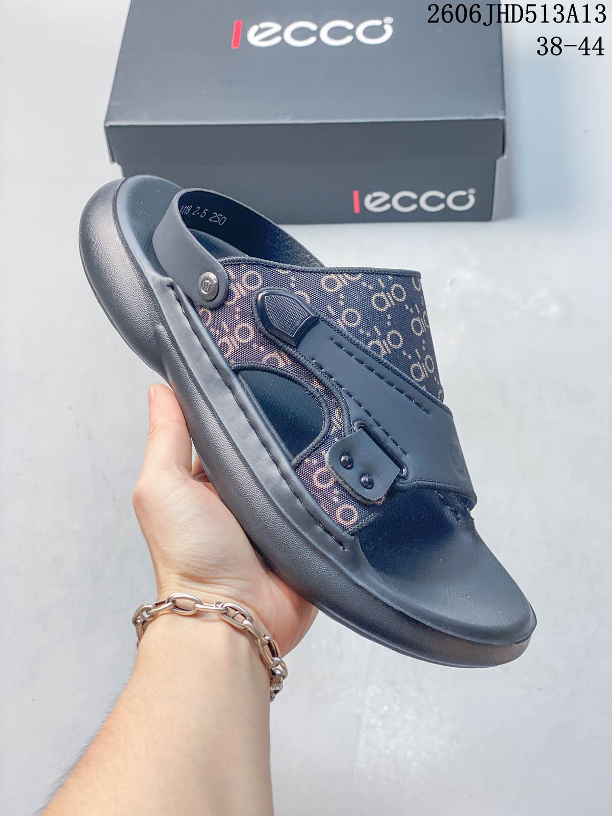 Close side view of a gray slide sandal with patterned panels and a thick gray sole.