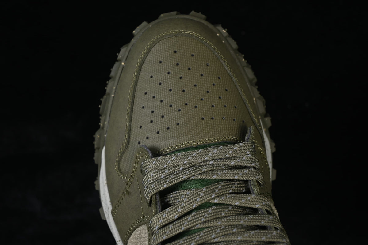 Close-up of the perforated olive toe and patterned laces.