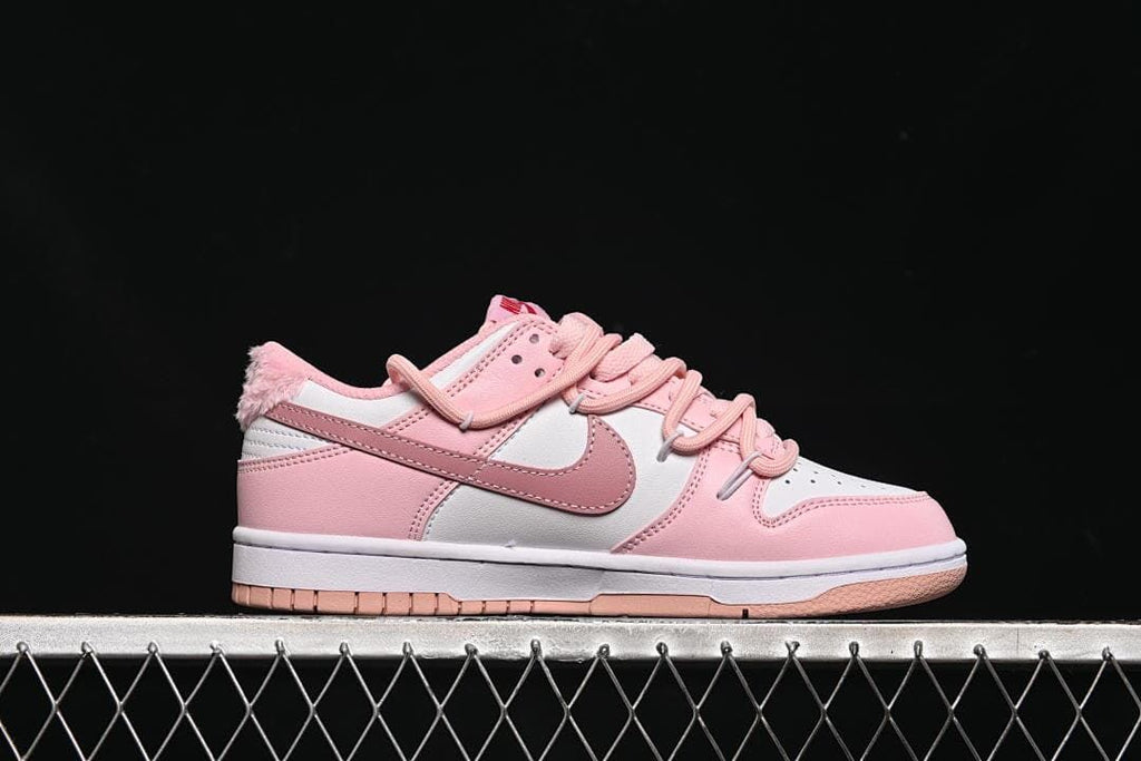 Side profile of the pink and white low-top sneaker.