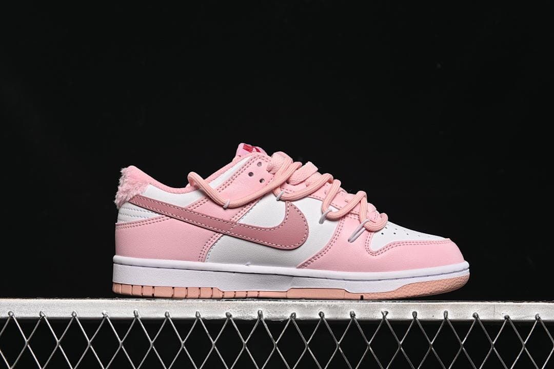 Side profile of the pink and white low-top sneaker.