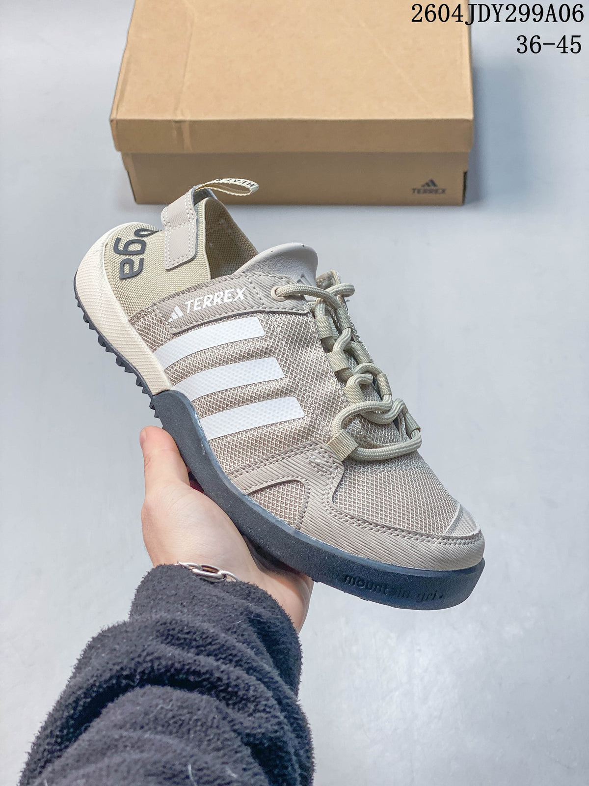 Angled view of a light beige Adidas Terrex lace-up shoe with white stripes and a dark outsole; image overlay reads 36–45.