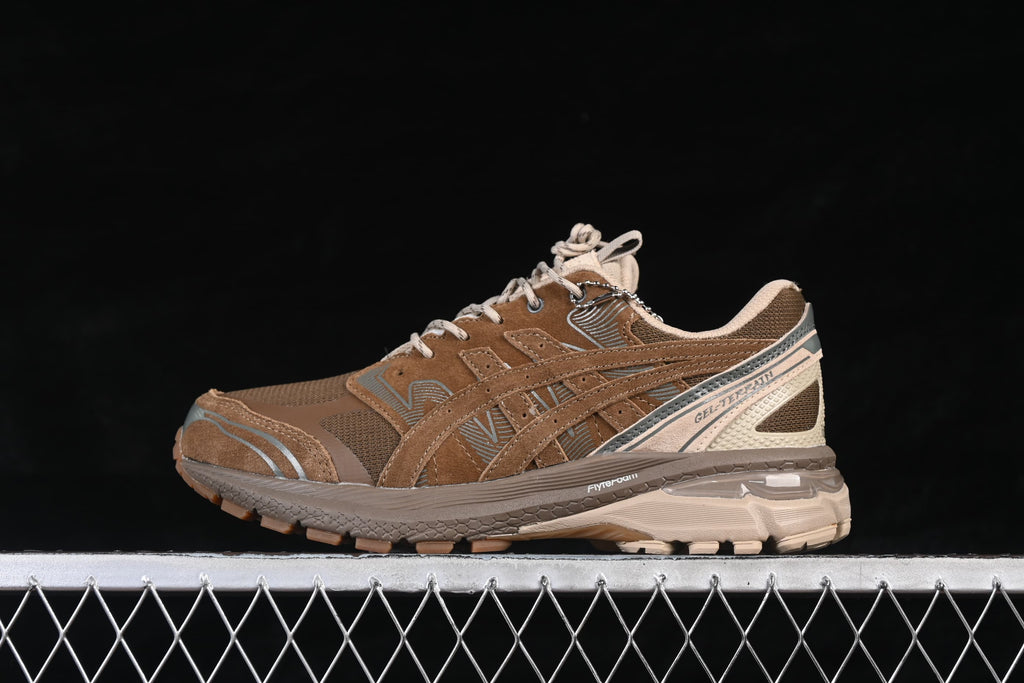 Side profile of the brown ASICS GEL-TERRAIN GTX sneaker.