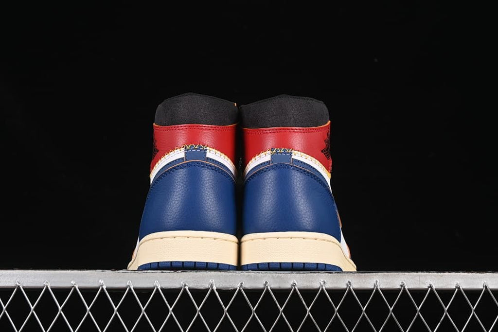 Rear view showing blue heel panels and red collars