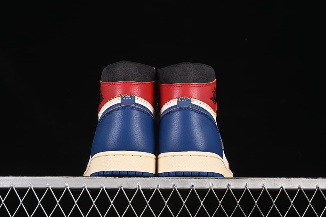 Rear view showing blue heel panels and red collars