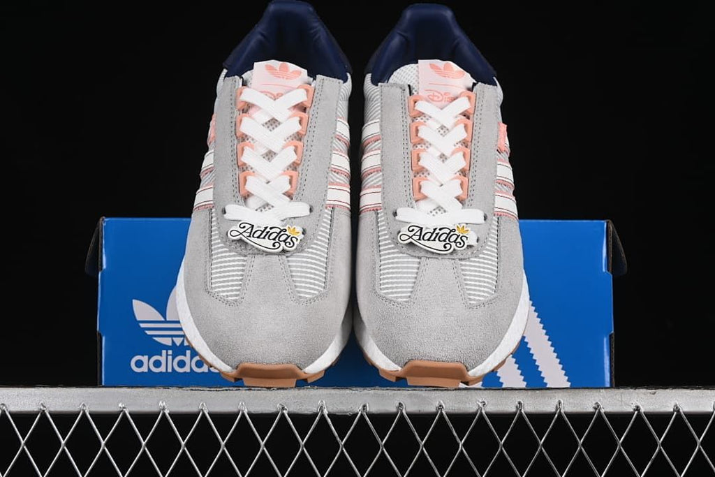 Front view of the pair of sneakers resting on a blue box