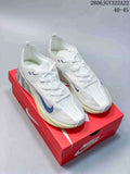 White Nike Ava X low-top shoes with blue Swoosh accents, shown on a red shoebox.