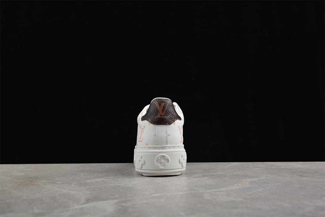 Rear view showing dark patterned heel panel and raised sole