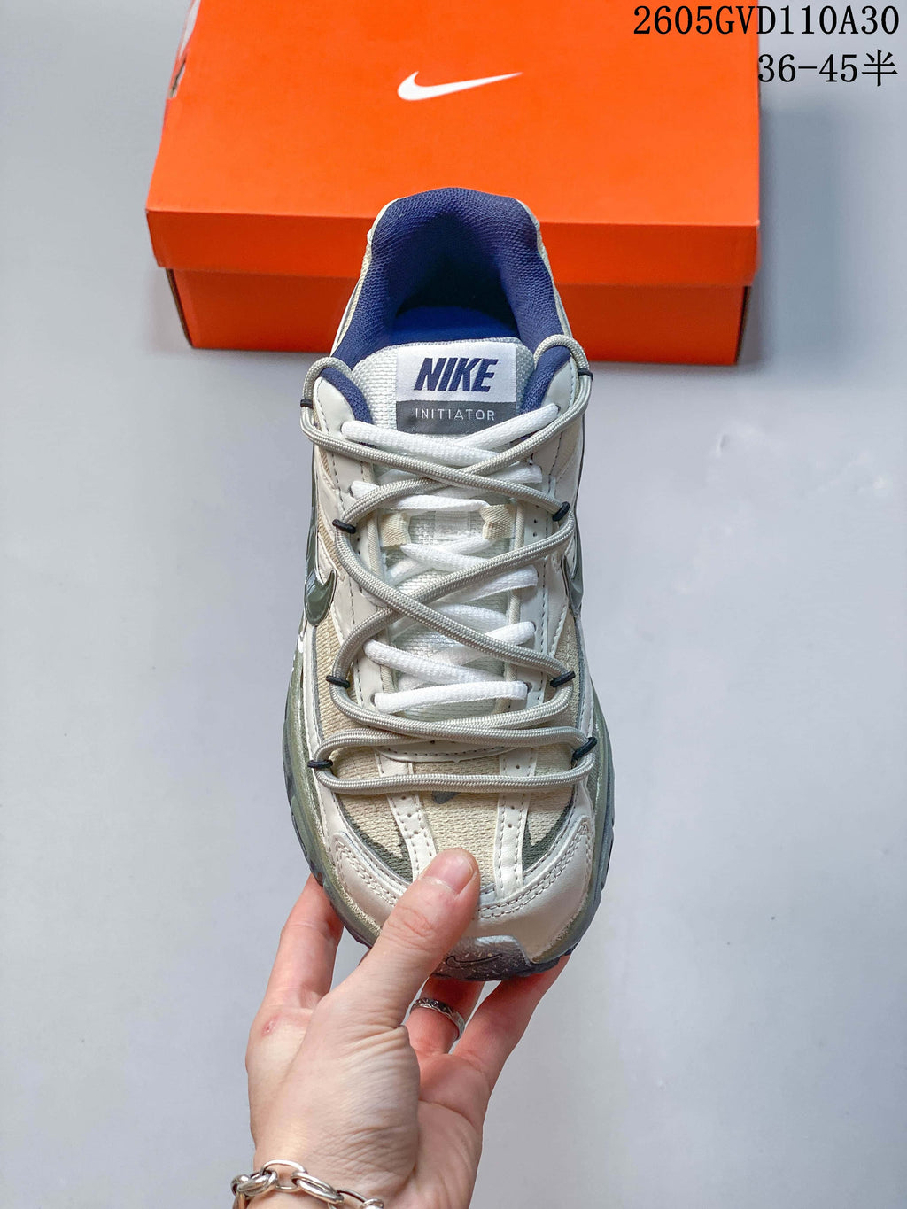 Front view of a Nike Initiator sneaker showing its laces, tongue label and blue collar lining
