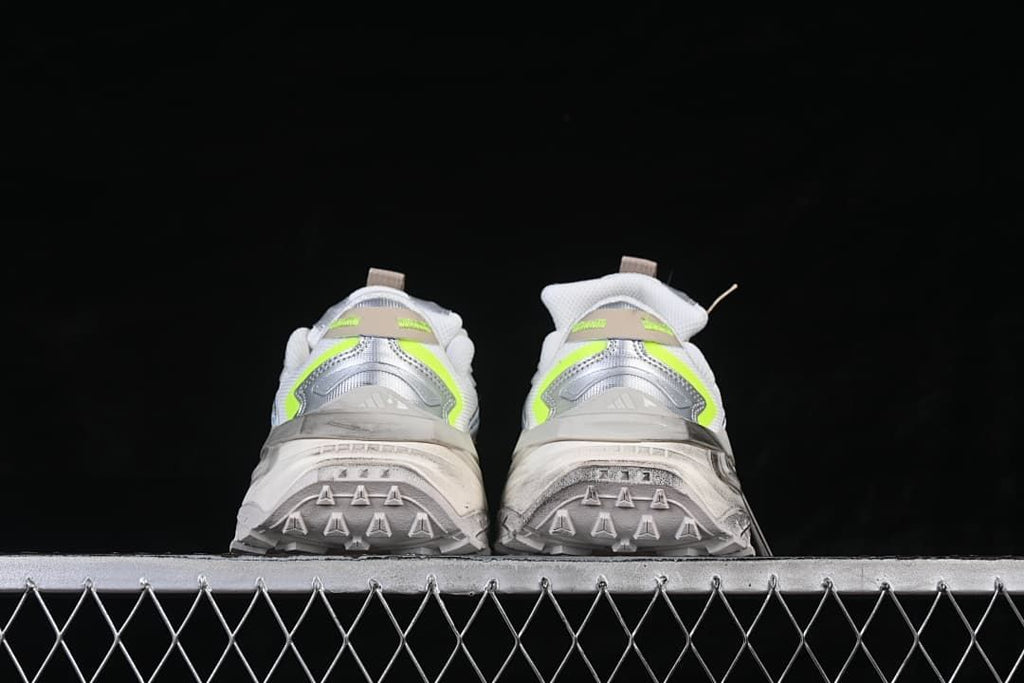 Rear view of both sneakers showing heel details and patterned outsole edges.