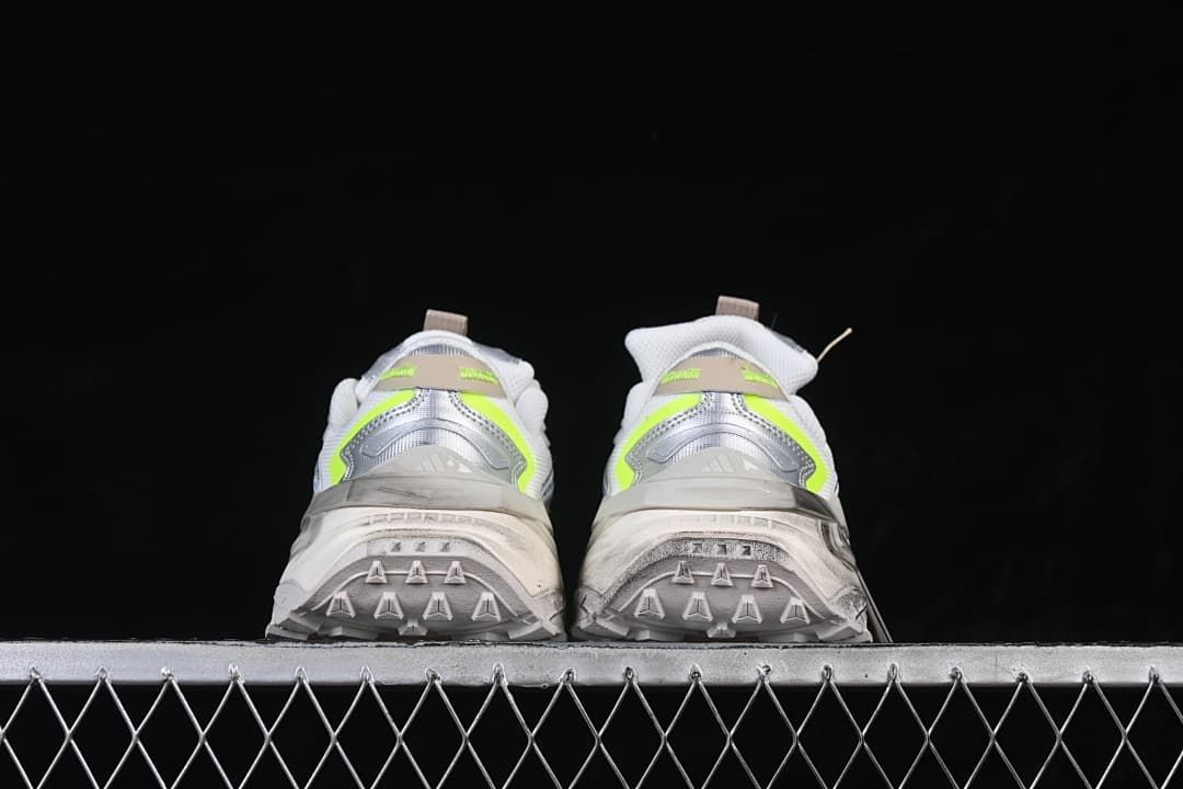 Rear view of both sneakers showing heel details and patterned outsole edges.