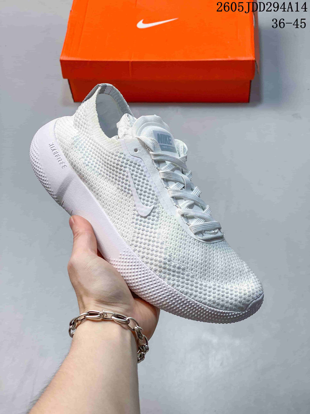 White Nike Free low-top sneaker with a textured upper and pale blue details.