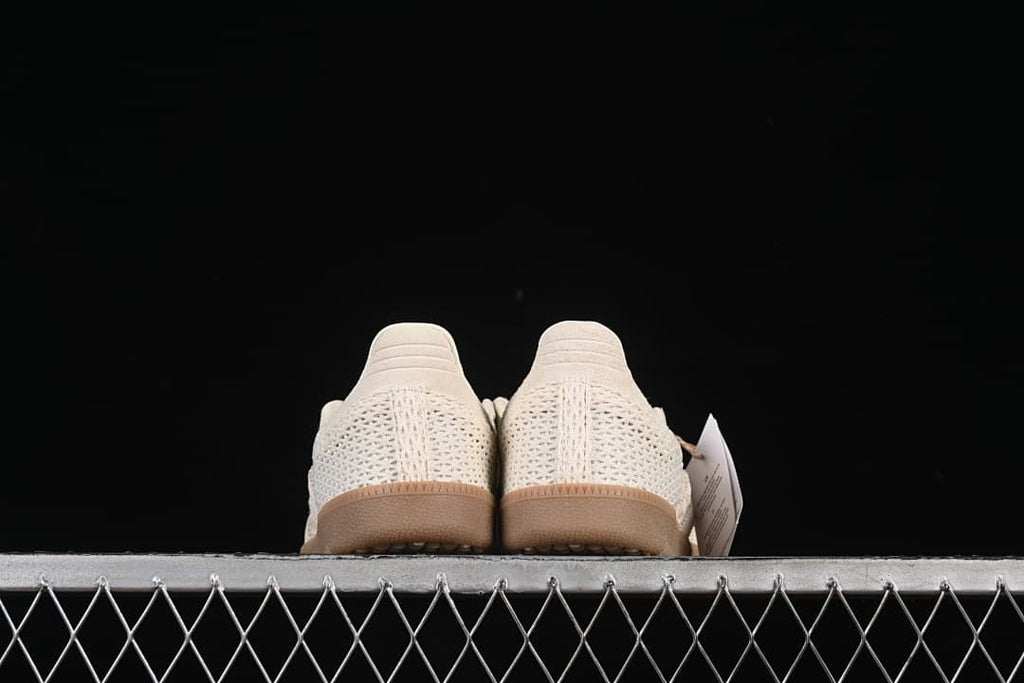 Rear view of both sneakers, showing the textured heel panels and gum-tone soles.
