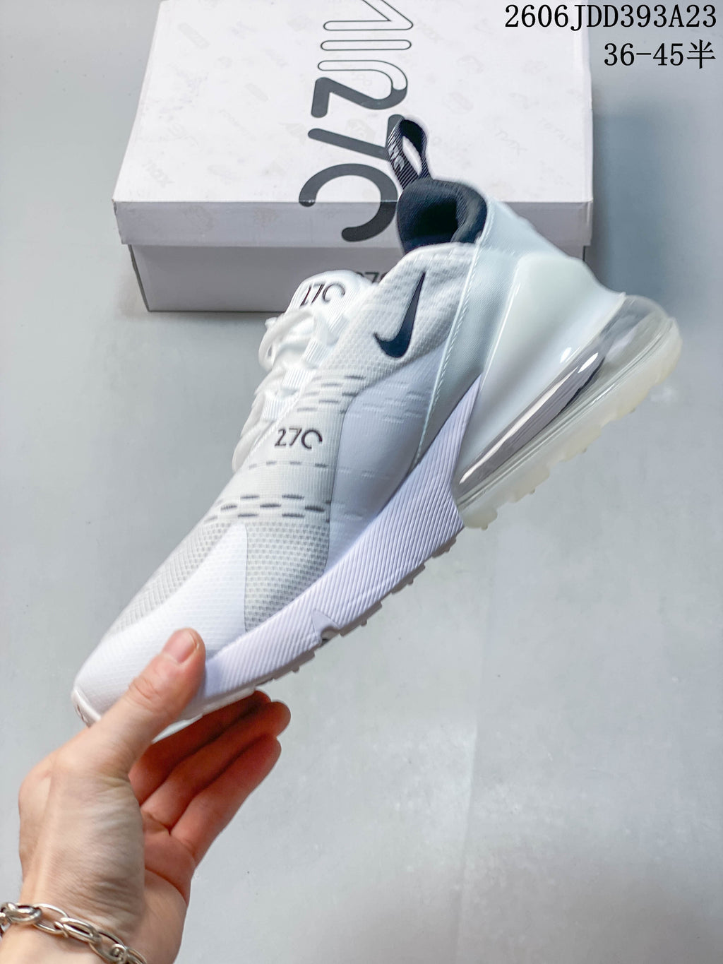 Side view of a white Nike Air Max 270 sneaker with dark accents