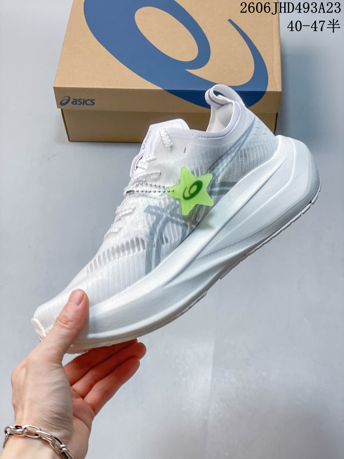 Side view of a white running shoe with silver-gray accents