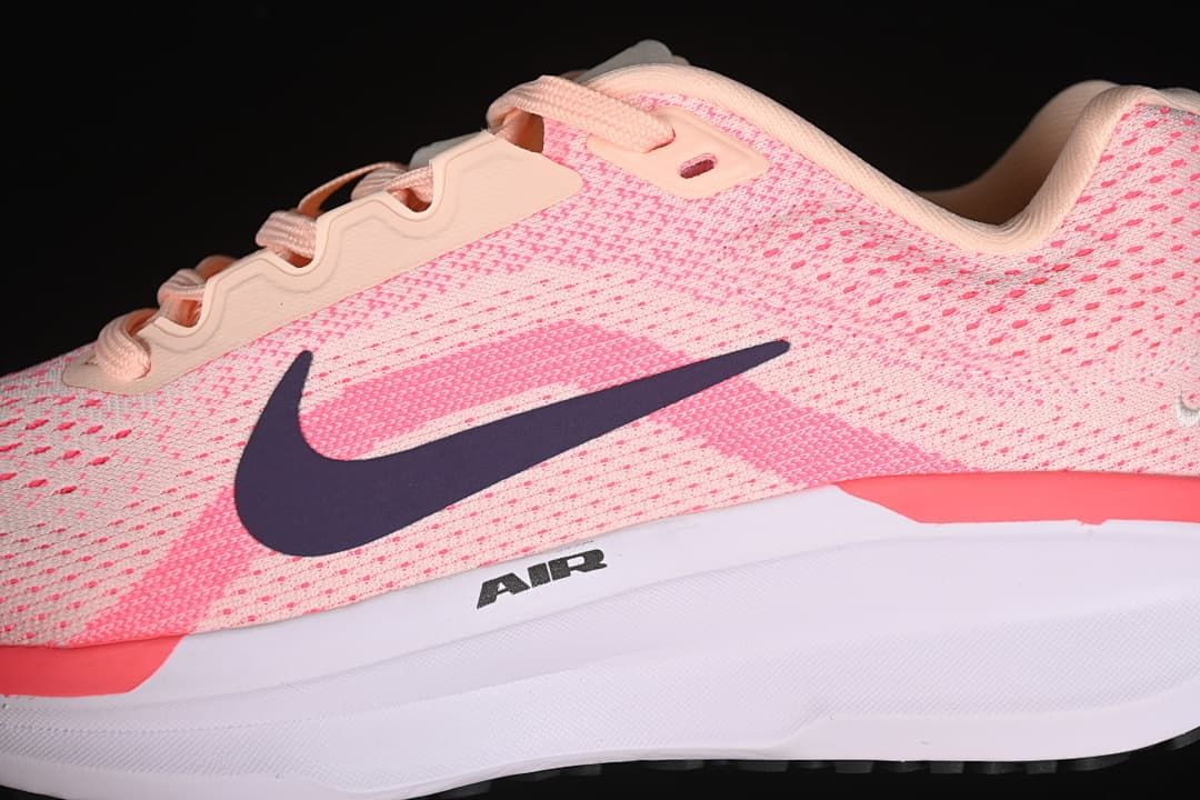 Close-up of the pink mesh upper, laces, dark Swoosh, and midsole.
