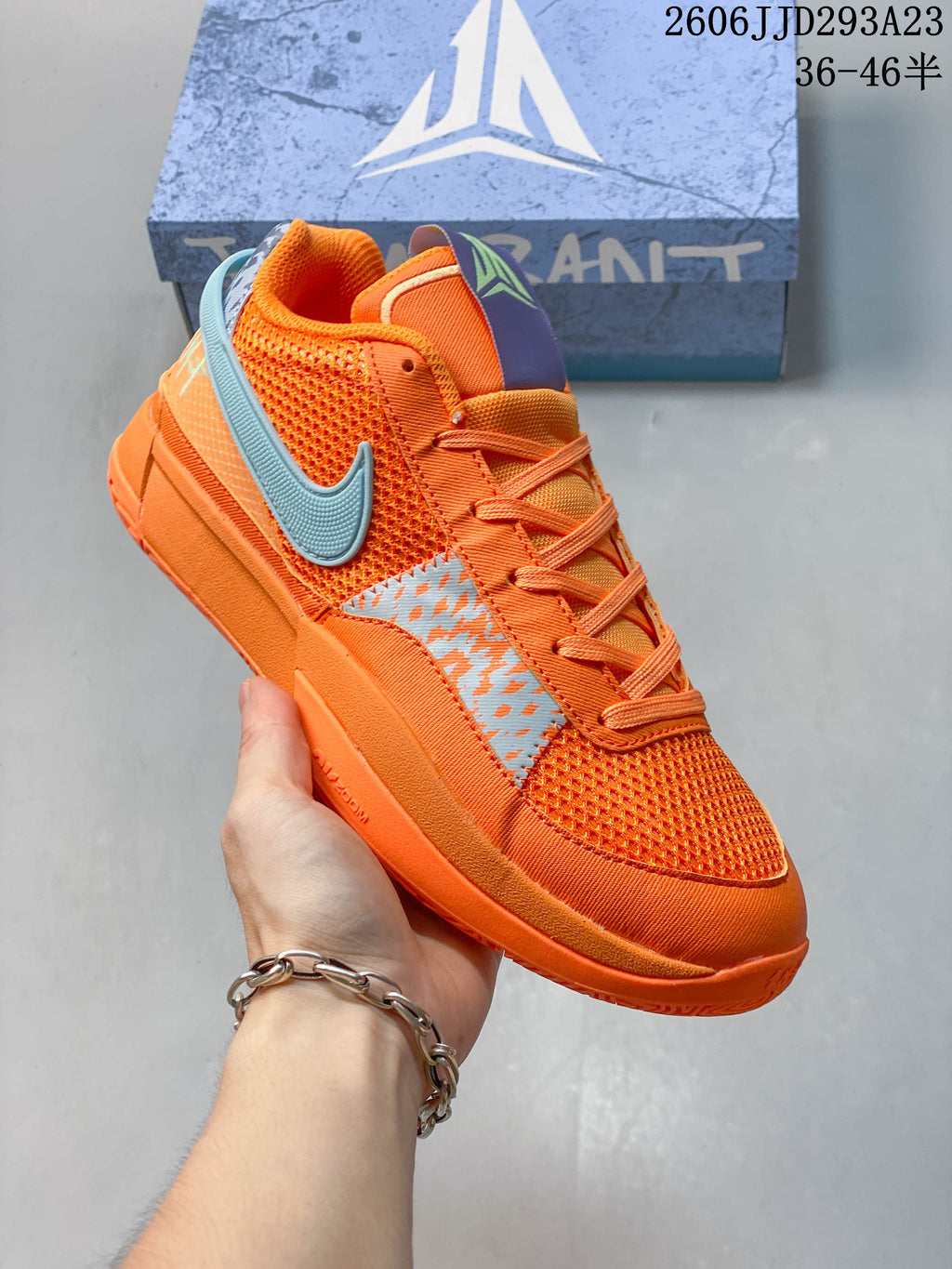 Angled view of the orange Nike Ja 1 EP with blue accents.