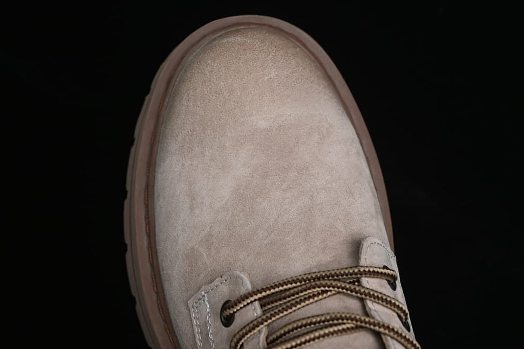 Top-down close-up of the rounded sand-colored toe and laces
