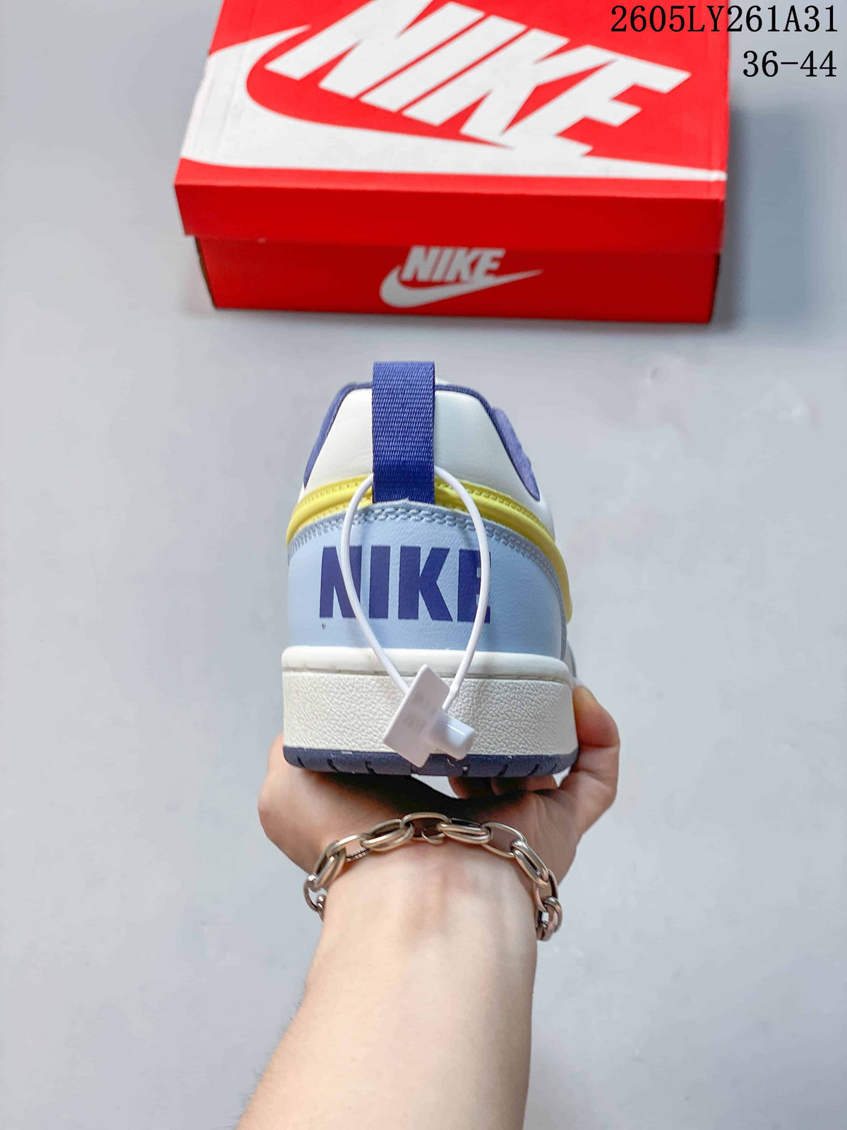 Rear view showing the NikeCourt Borough sneaker heel, navy pull tab, and contrasting panels