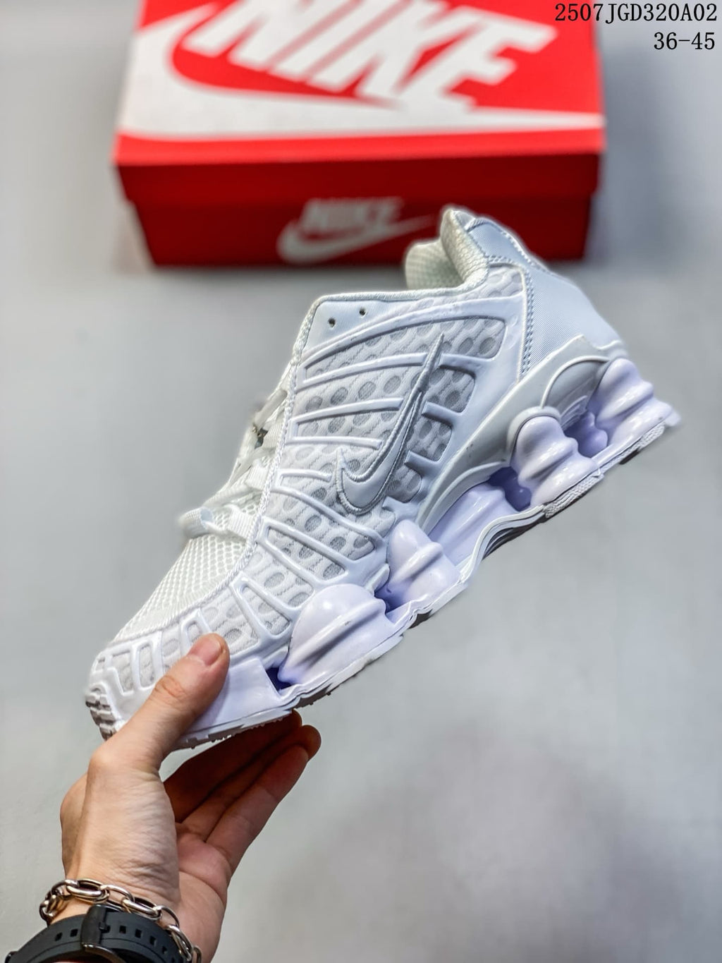 Side view of the white Nike Shox TL sneaker with sculpted sole columns