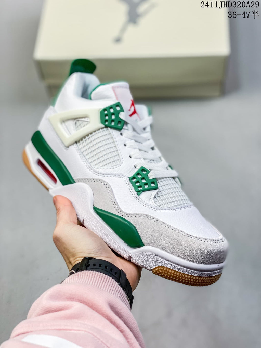 Angled view of the white and green mid-top sneaker