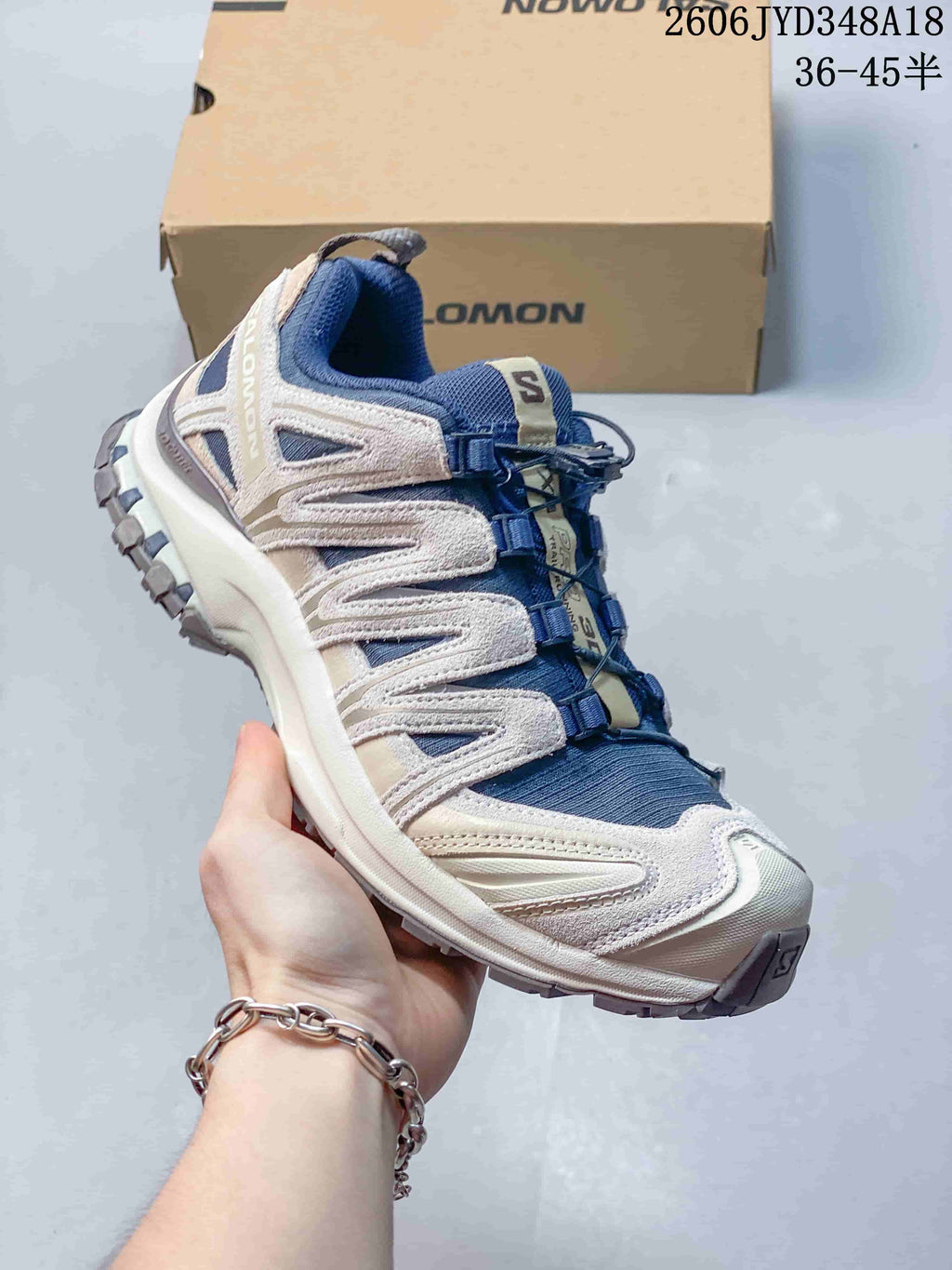 Angled view of a blue and off-white Salomon XT-3D trail shoe