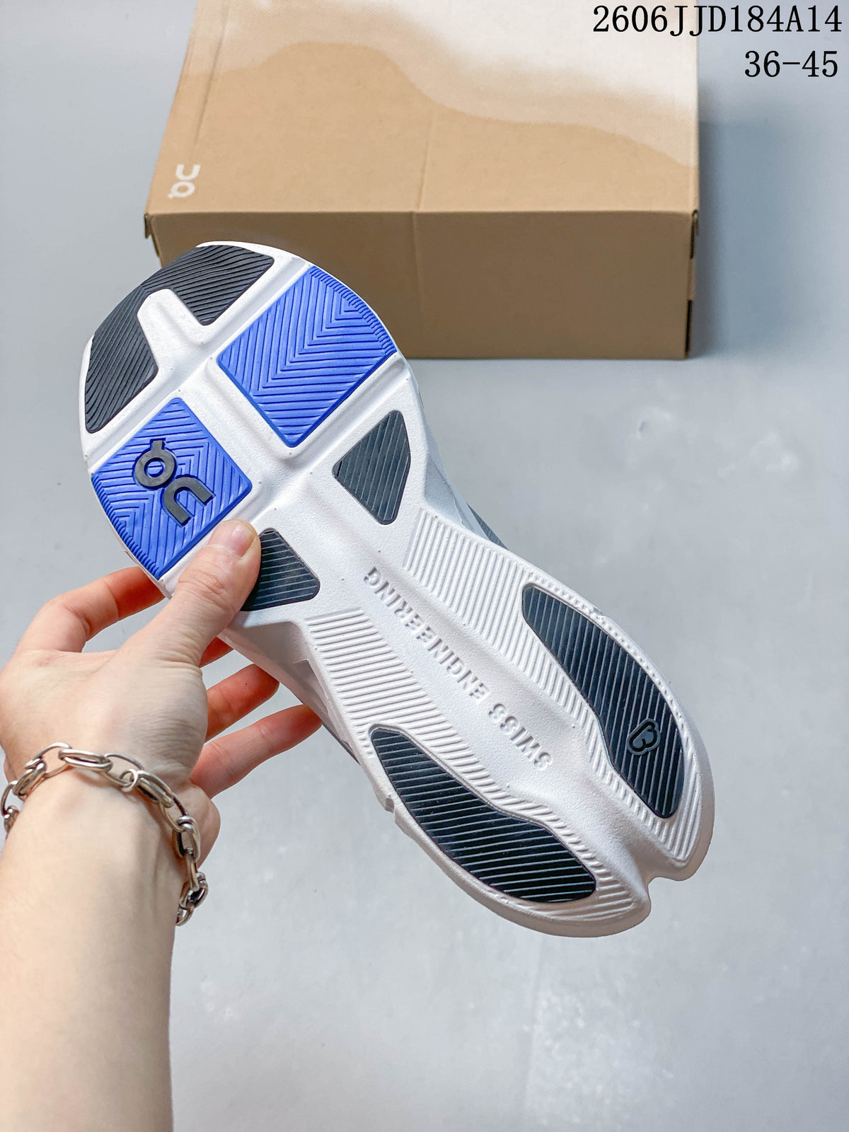 Underside of the sneaker showing a white sole with blue and dark tread sections