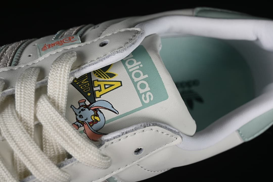 Close-up of tongue graphics, laces, and pale aqua interior