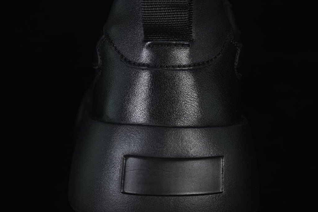 Rear view of the sneaker with heel pull tab and raised sole