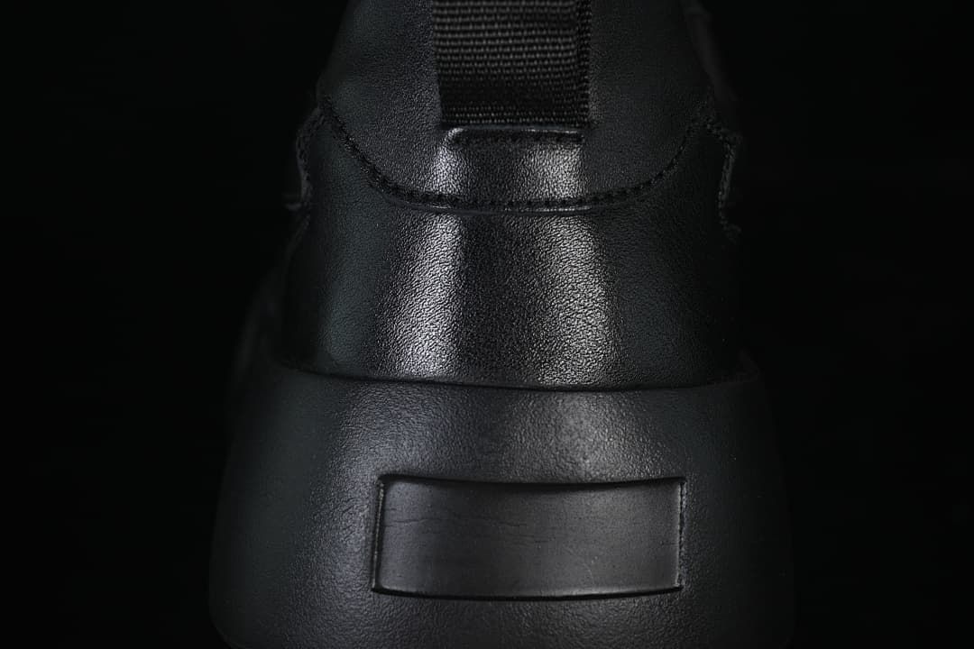 Rear view of the sneaker with heel pull tab and raised sole