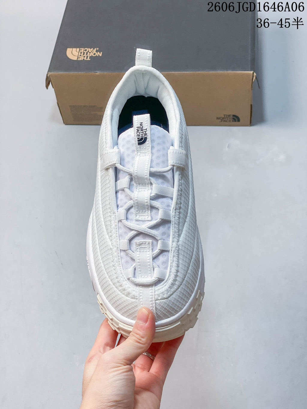 Top view of the white shoe showing its lace-style front and pull tab.