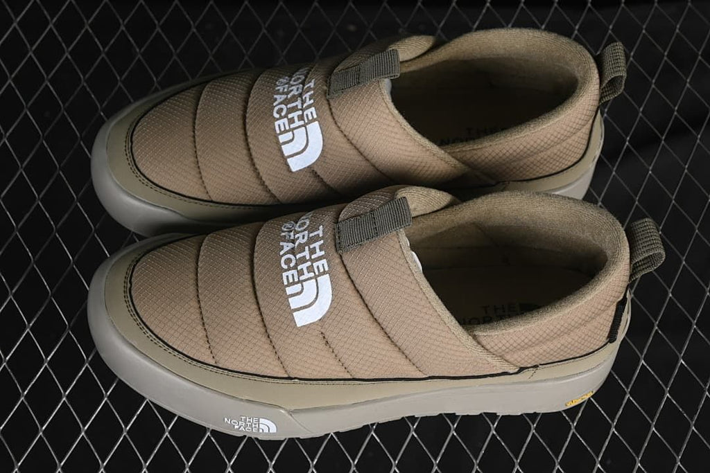 Pair of khaki slip-on shoes viewed from above