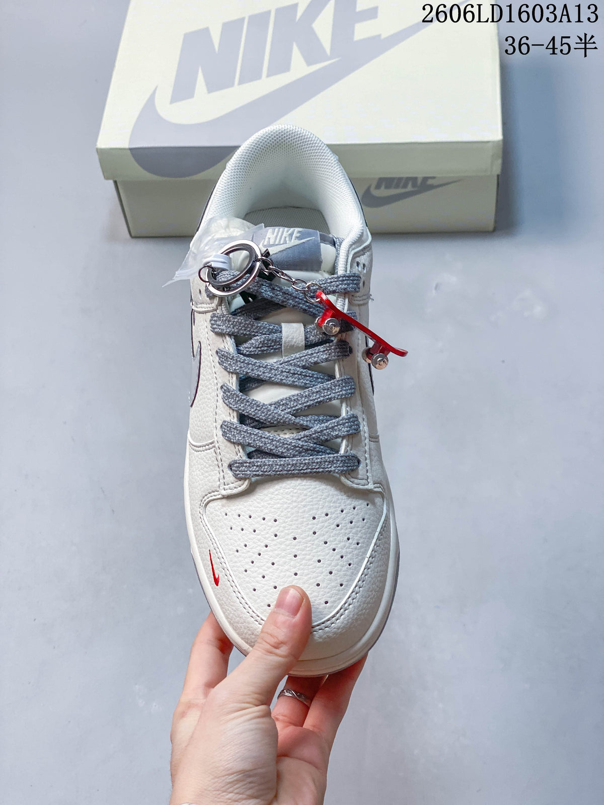 Top view showing perforated toe, grey laces, and decorative accessories