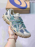ASICS Gel-Kahana 8 sneaker in light grey with teal and blue accents, shown beside a shoe box.
