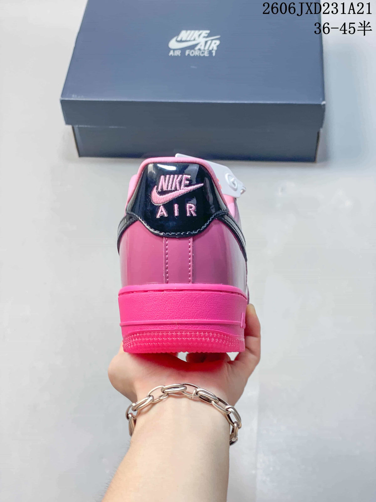 Rear view of a pink Nike Air Force 1 sneaker with dark heel detail