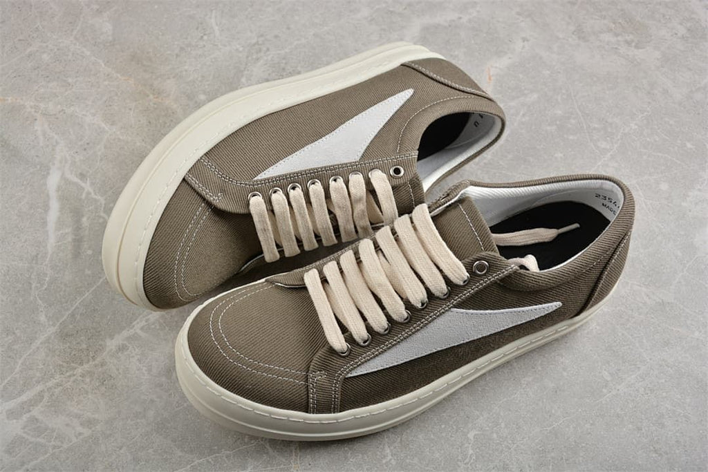 Pair of brown canvas low-top sneakers with cream laces and thick off-white soles