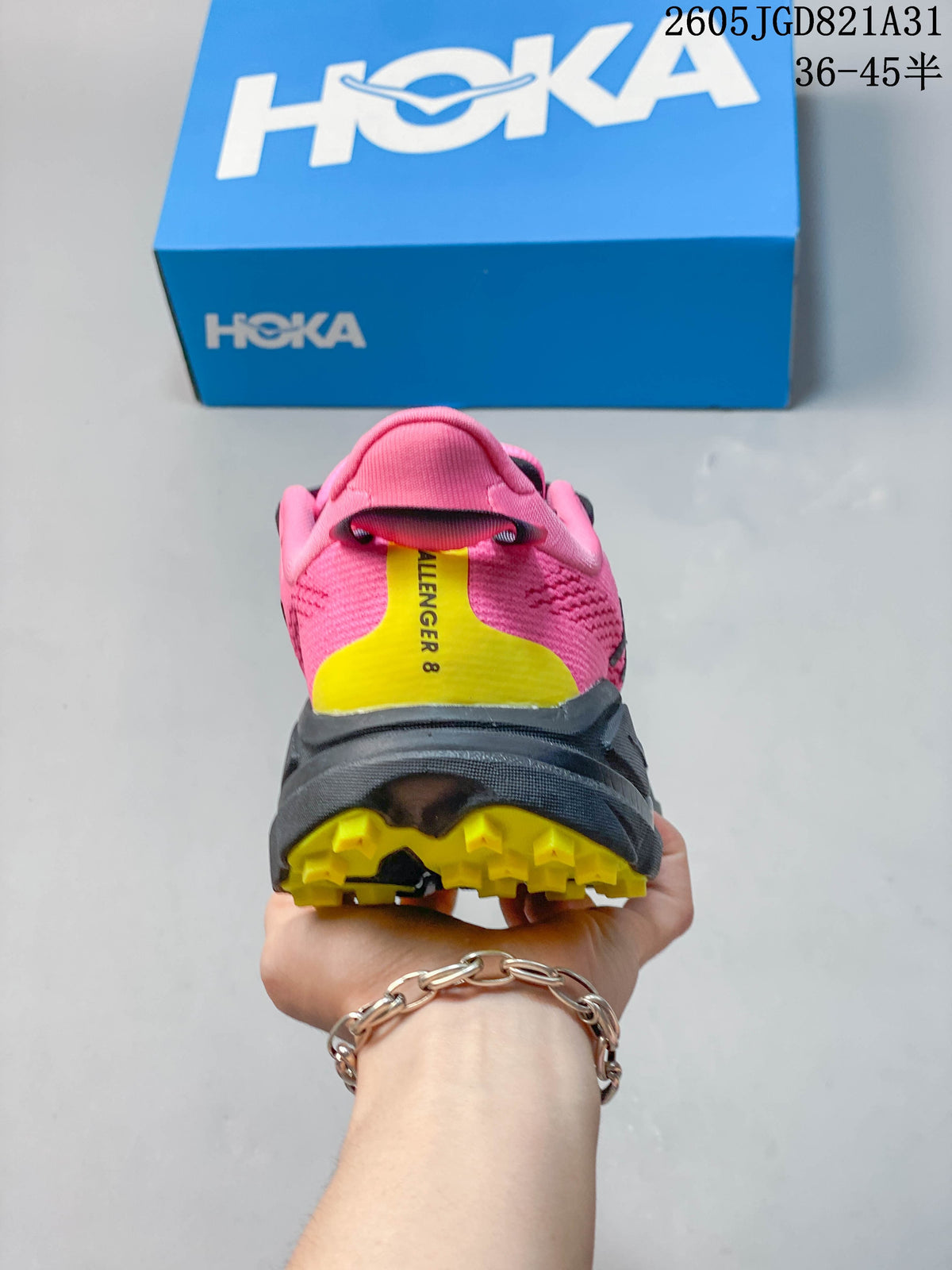 Rear view showing the pink heel, yellow accent panel and lugged outsole.