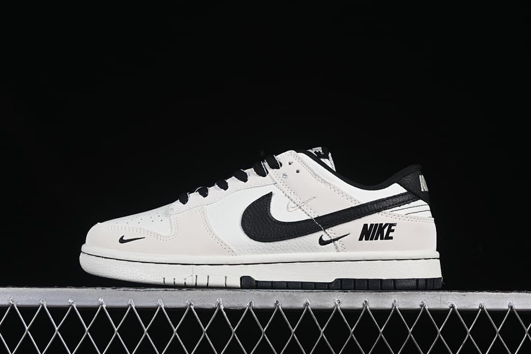 Side view of a white and black Nike SB Dunk Low sneaker with contrasting Swoosh details.