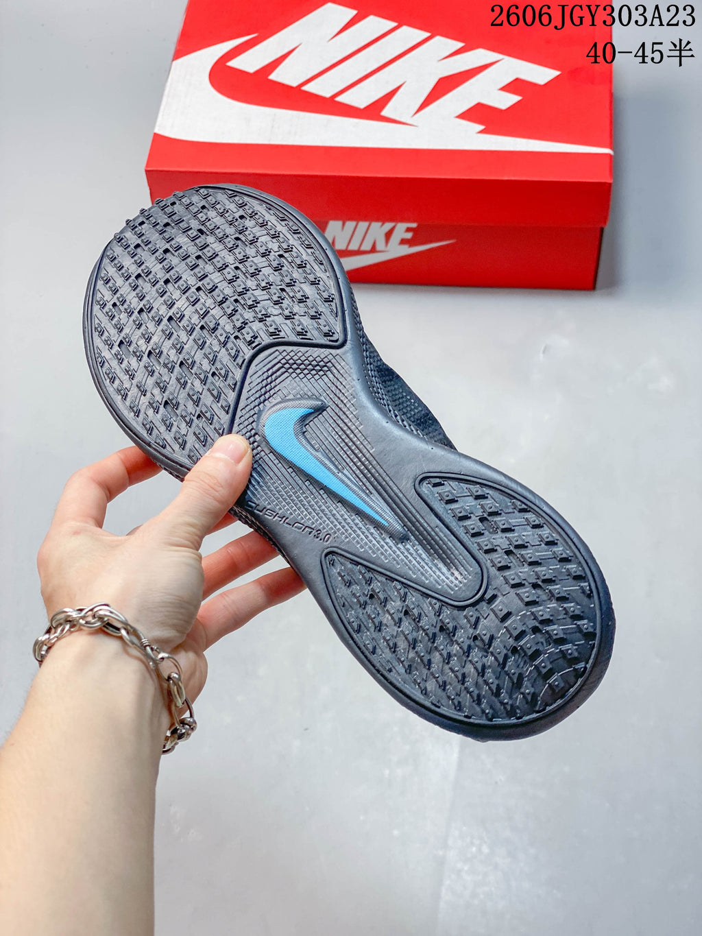 Close-up of the patterned outsole and blue logo detail on a Nike Ava Rover shoe