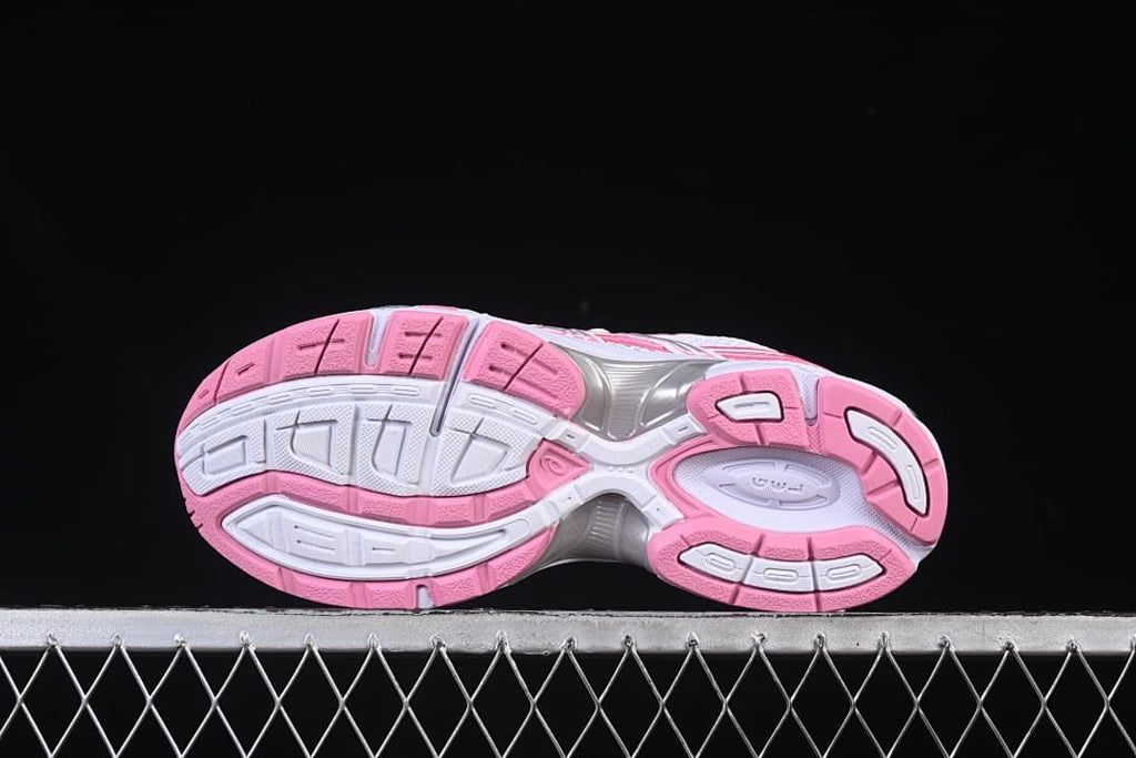 Underside view of the sneaker with a white and pink patterned outsole.