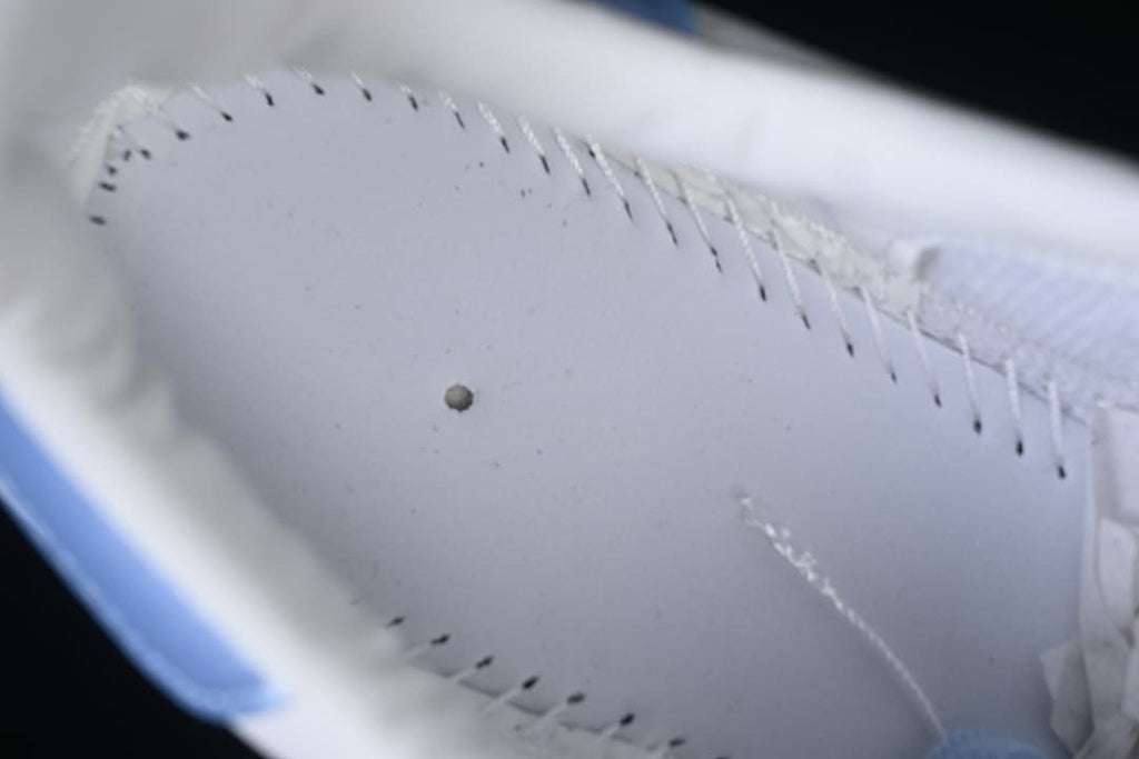 Close-up view inside the sneaker showing stitching and pale blue trim.