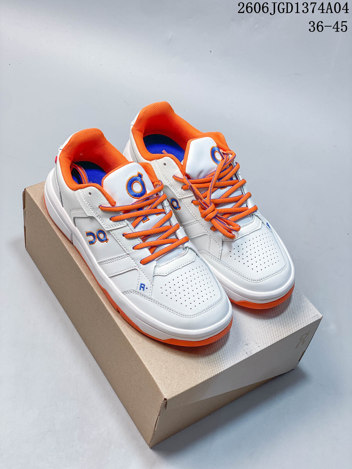 Pair of white On THE Roger Clubhouse sneakers with orange laces and lining, blue details, and orange outsole accents